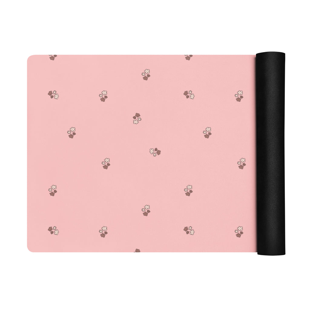 Pale pink yoga mat with small images of flowers.