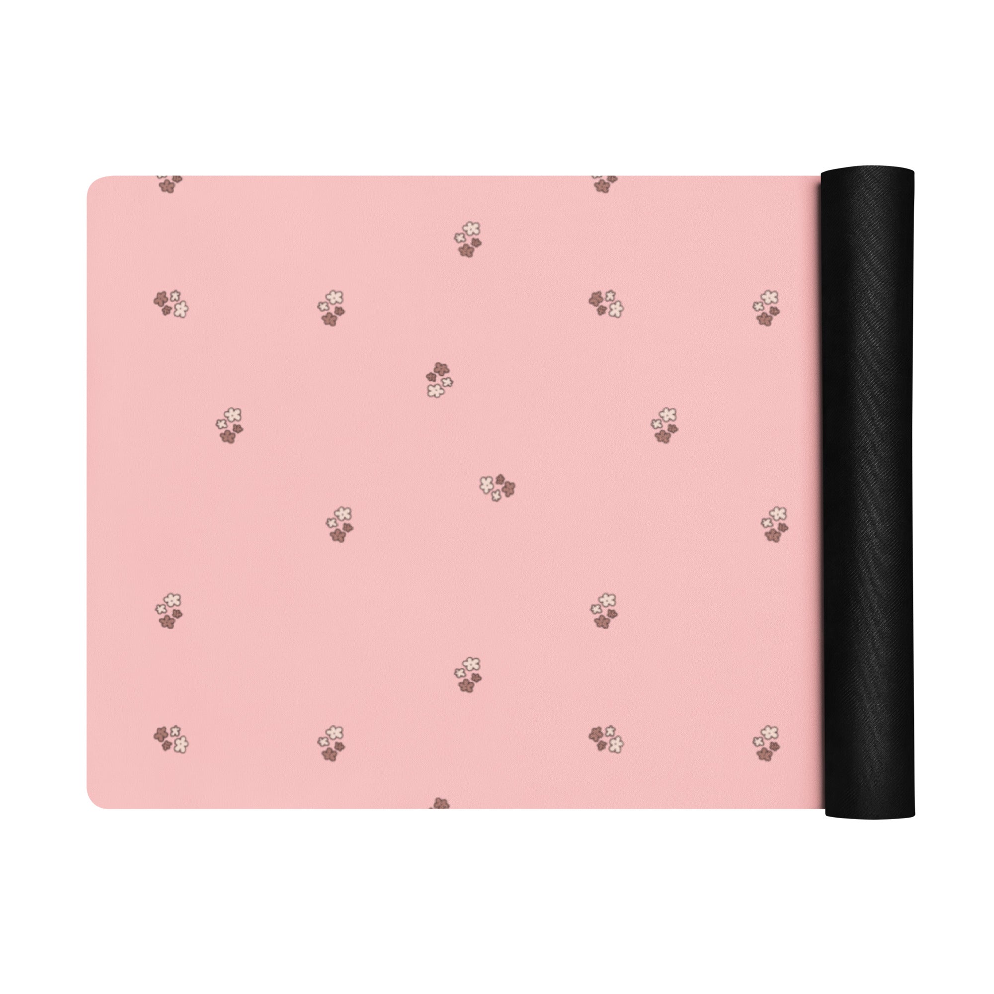 Pale pink yoga mat with small images of flowers.