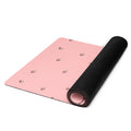 Pale pink yoga mat with small images of flowers.