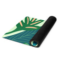 Jungle print/leaf print yoga mat with lots of blue, green, pink tones.