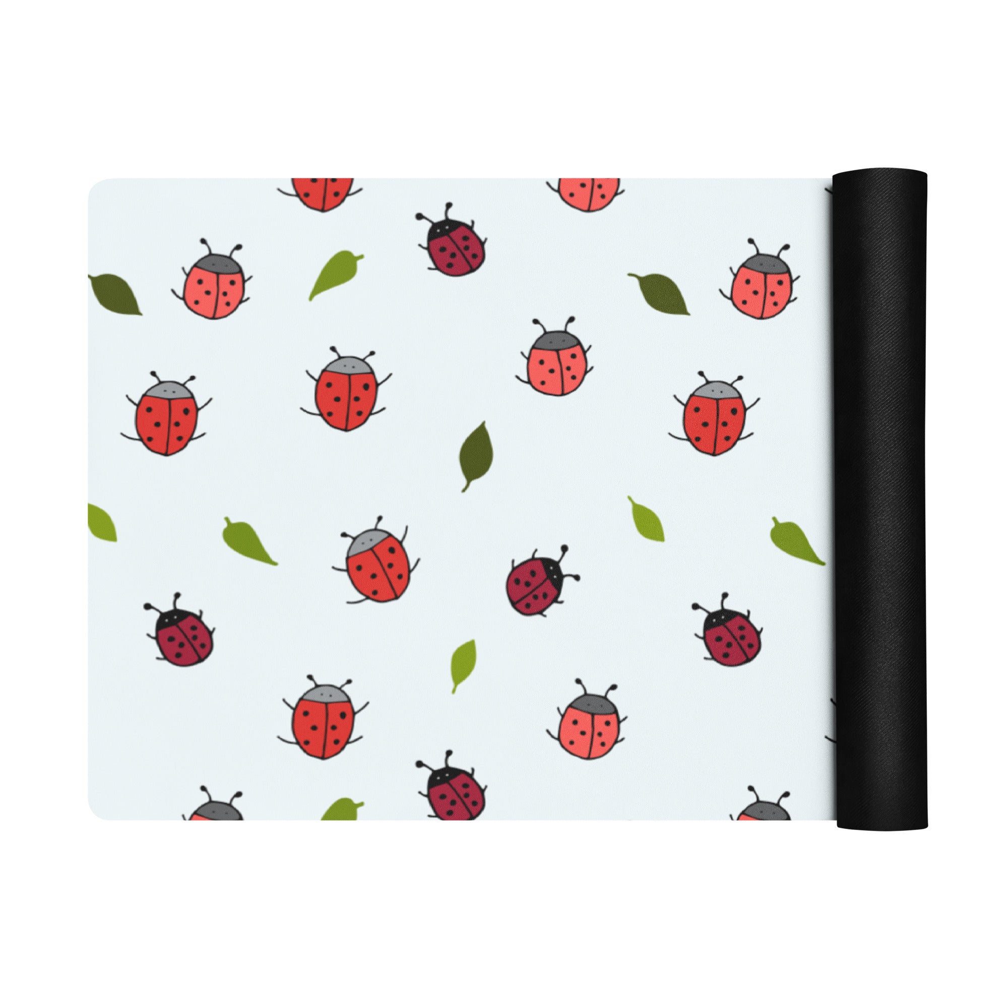 Ladybird print yoga mat on a neutral background. Red ladybirds or ladybugs with green leaves. 