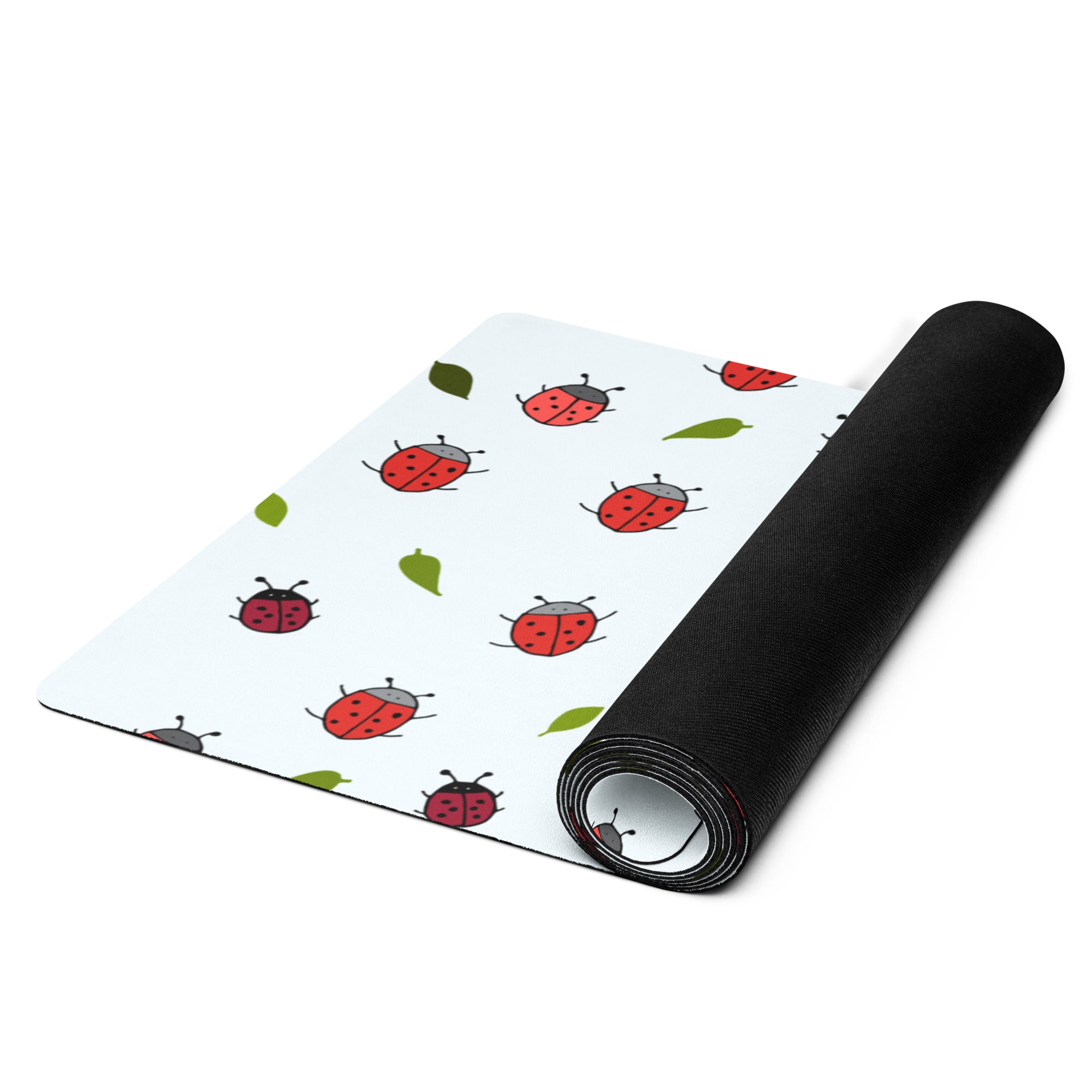 Ladybird print yoga mat on a neutral background. Red ladybirds or ladybugs with green leaves. 