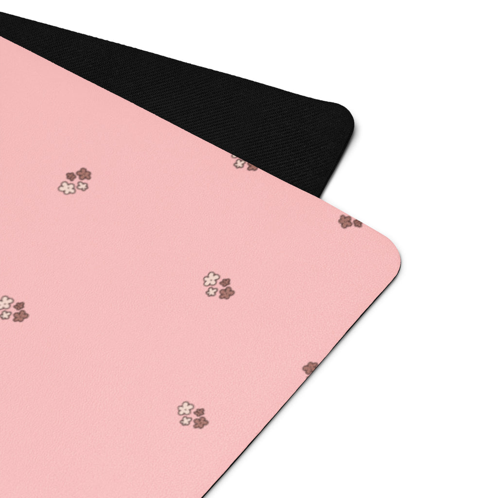 Pale pink yoga mat with small images of flowers.