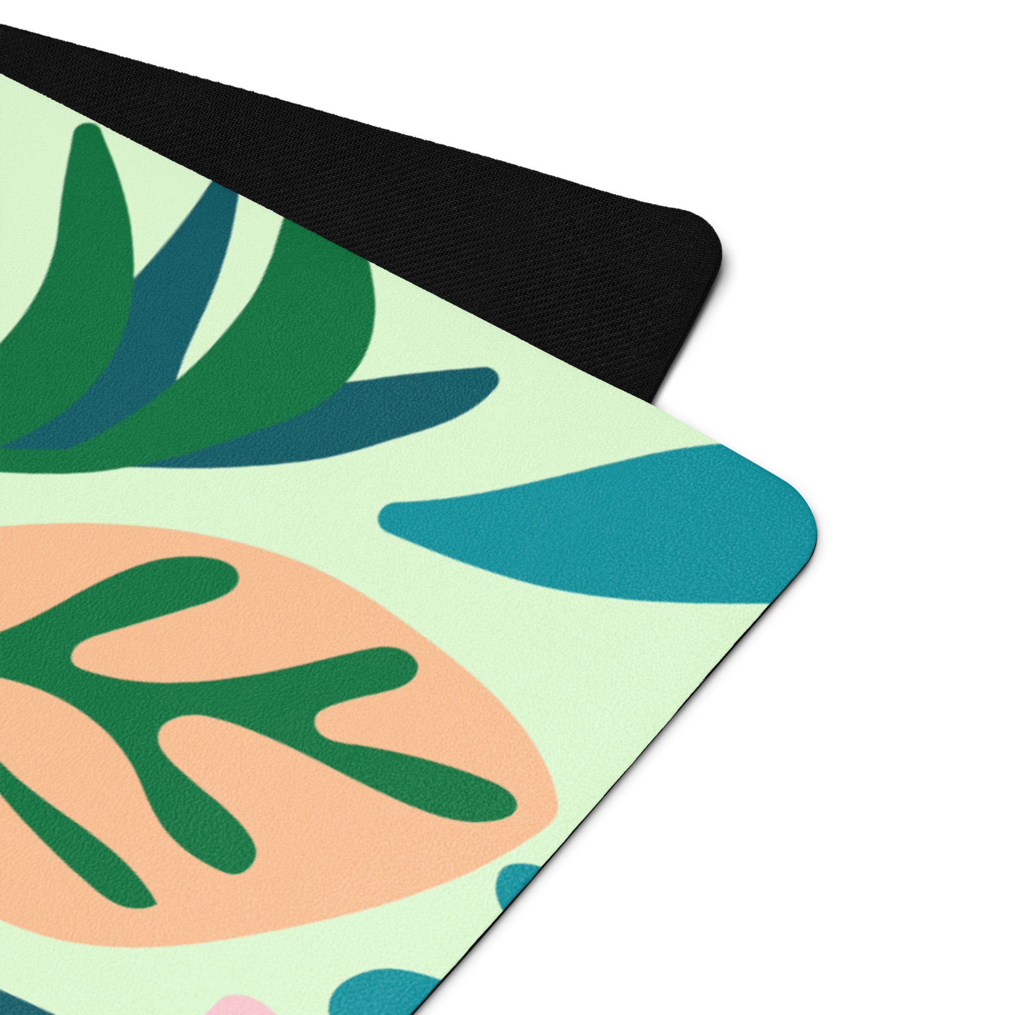 Jungle print/leaf print yoga mat with lots of blue, green, pink tones.